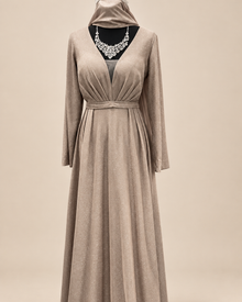 Robe longue taupe scintillante sur fond beige
